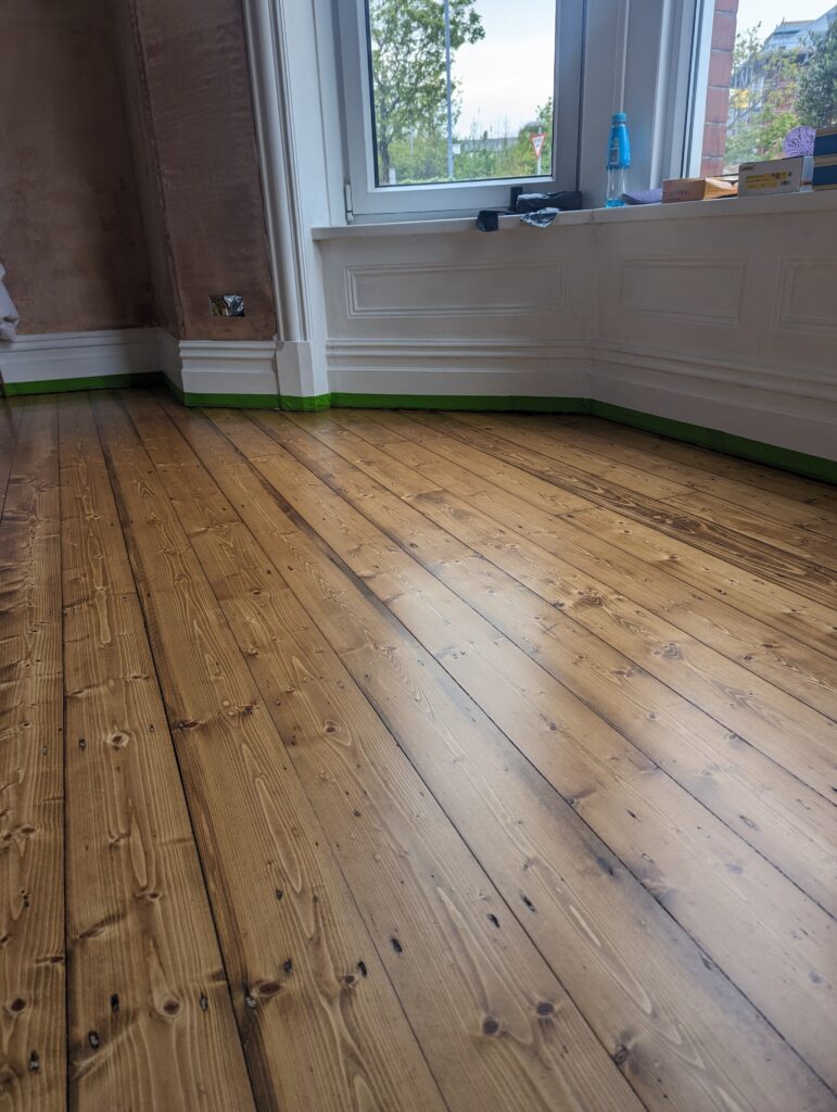 Pine wooden floorboards sanded, stained and lacquered in Barrow In Furness, Cumbria